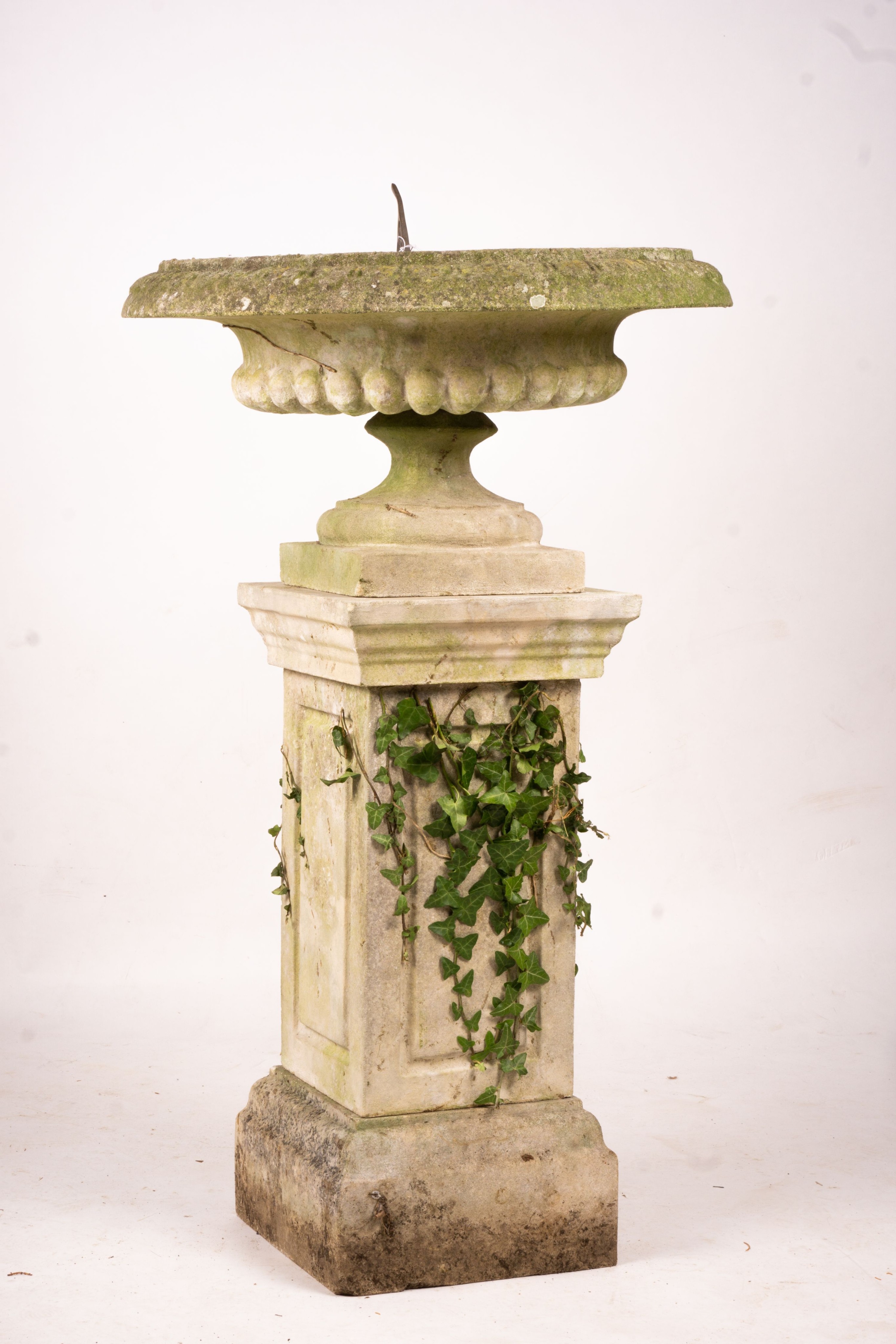 A reconstituted stone garden bird bath combined sundial on square pedestal base, height 108cm